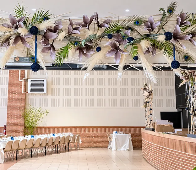 Salle de séminaire décorée de suspensions florales et de plumes